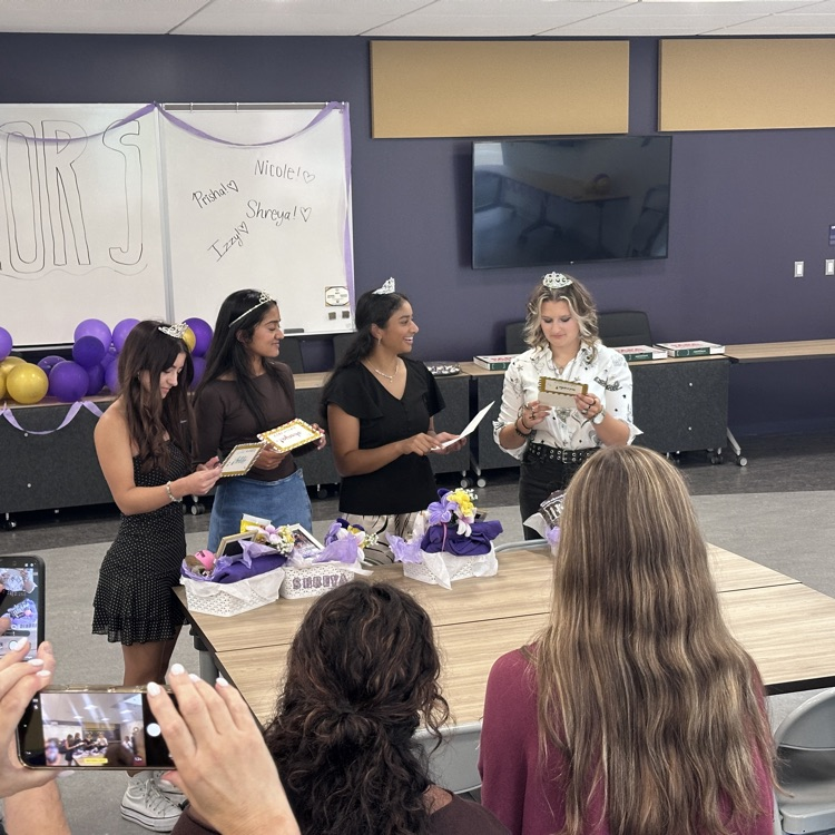 Enjoying gifts from their teammates.