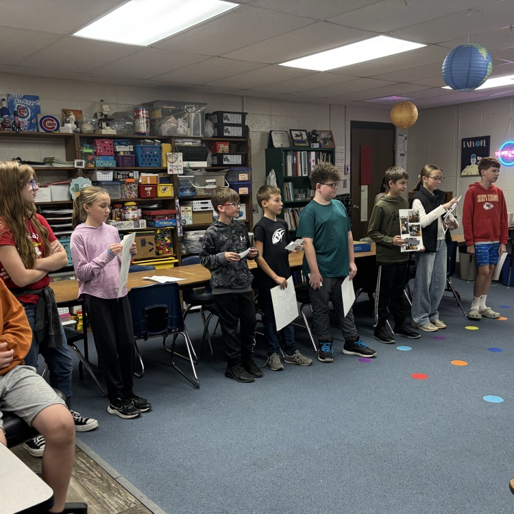 robot club practice their presentation for competition with a group of highschoolers, pretending to be judges.