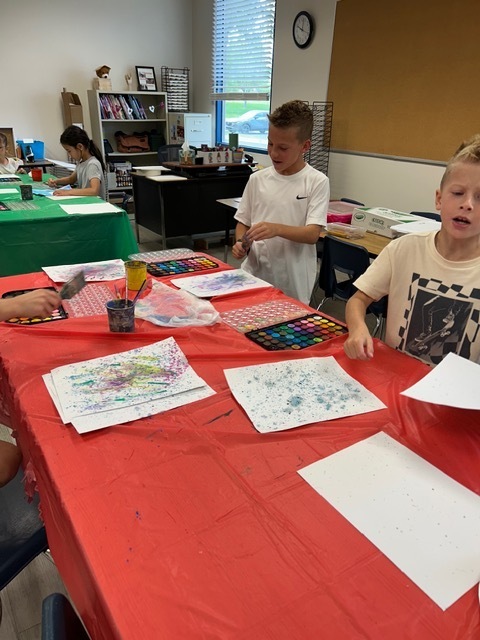 3 students creating with art