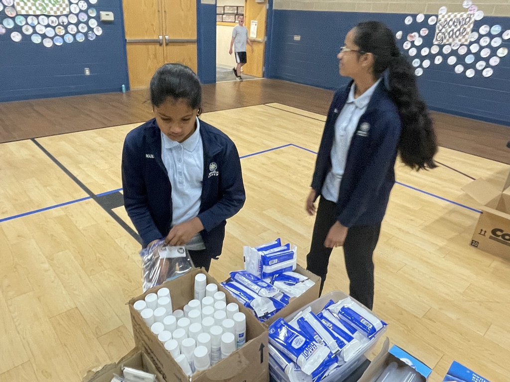 2 girls packing hygiene kits