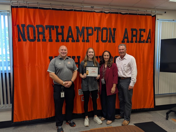 NAHS student is photographed with HS principal, NASD Assistant Superintendent and Superintendent of Schools