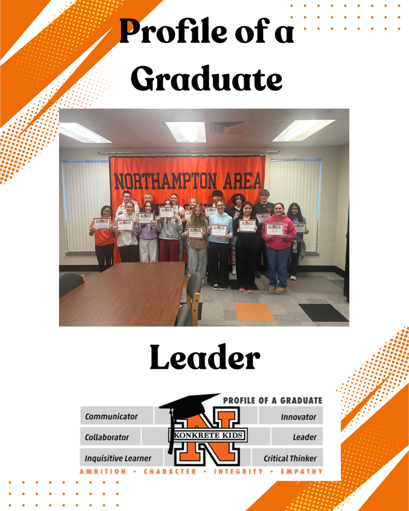 A picture of students standing in front of the NASD banner holding their student of the month certificates.