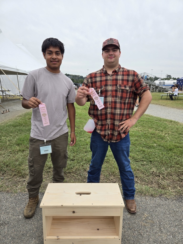 students pose with their tool bench and 4th place ribbon