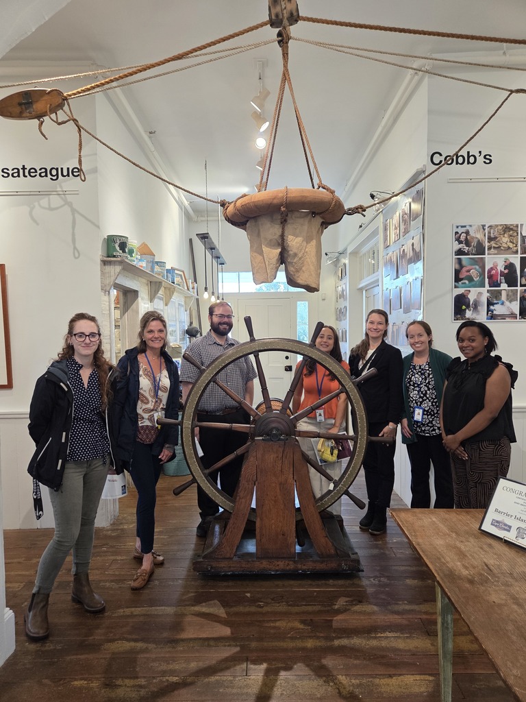 group picture at a ship wheel