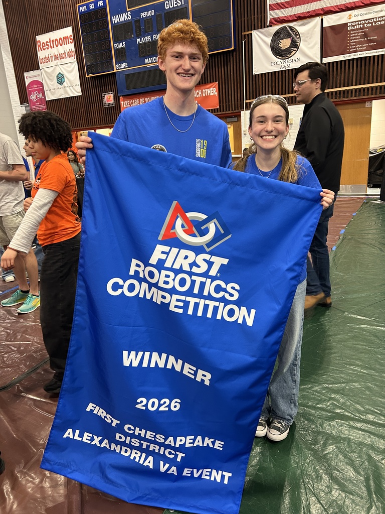 Student robotics captains pose with their 1st place banner