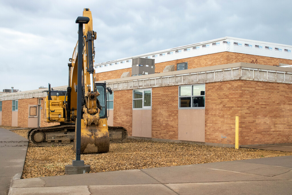 Backhoe to be used to demolish the east side of the building.