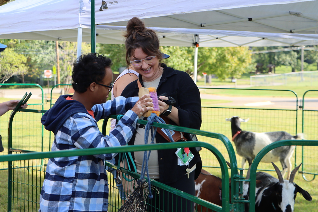 Staff and student brushing animal