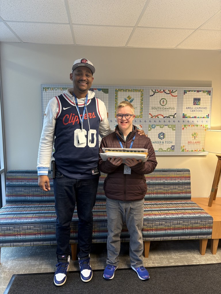 Staff and student helping out with mail delivery. 