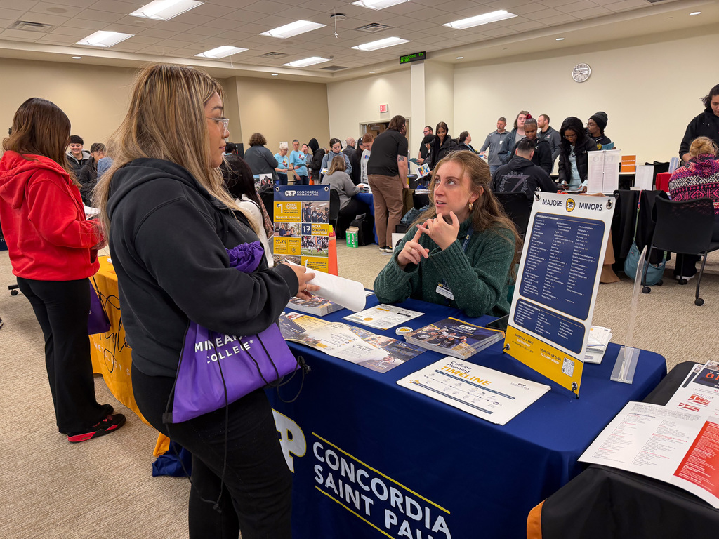 A student talking to a college vendor.
