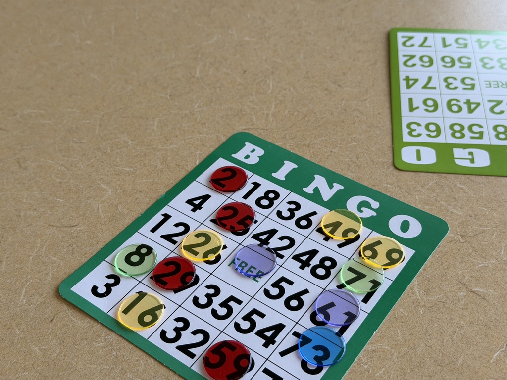 An image of a bingo card with plastic chips on the numbers. 