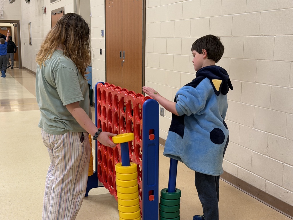 Student playing with a big Connect Four toy. 