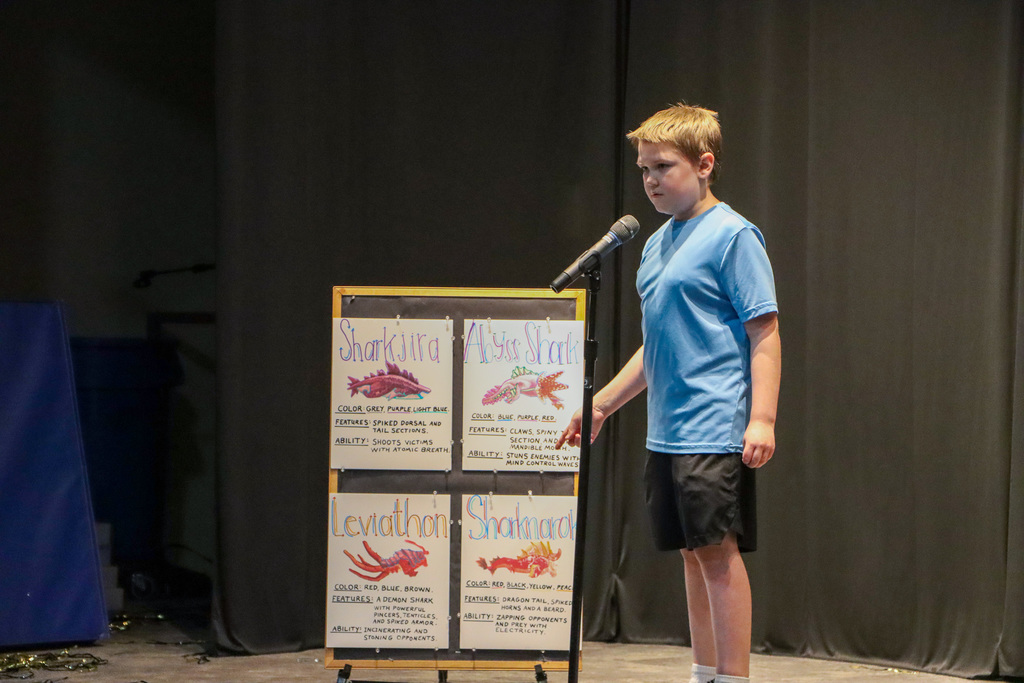 Student explaining the different kind of sharks that they drew. 
