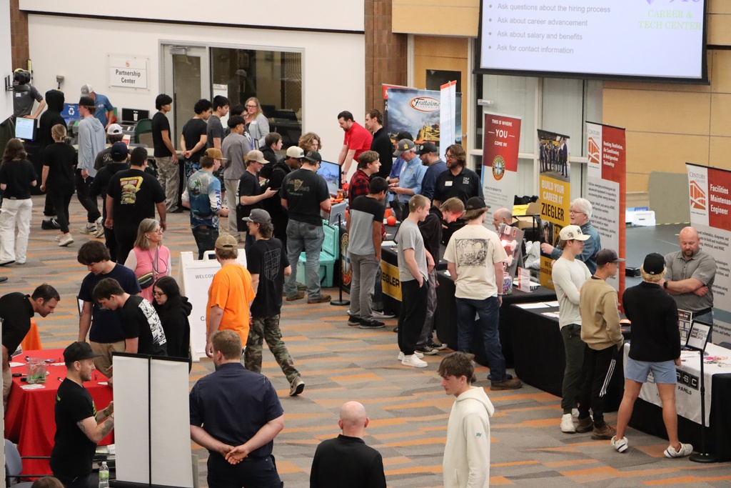 A view of students going around to industry professional booths and talking with them about their careers.