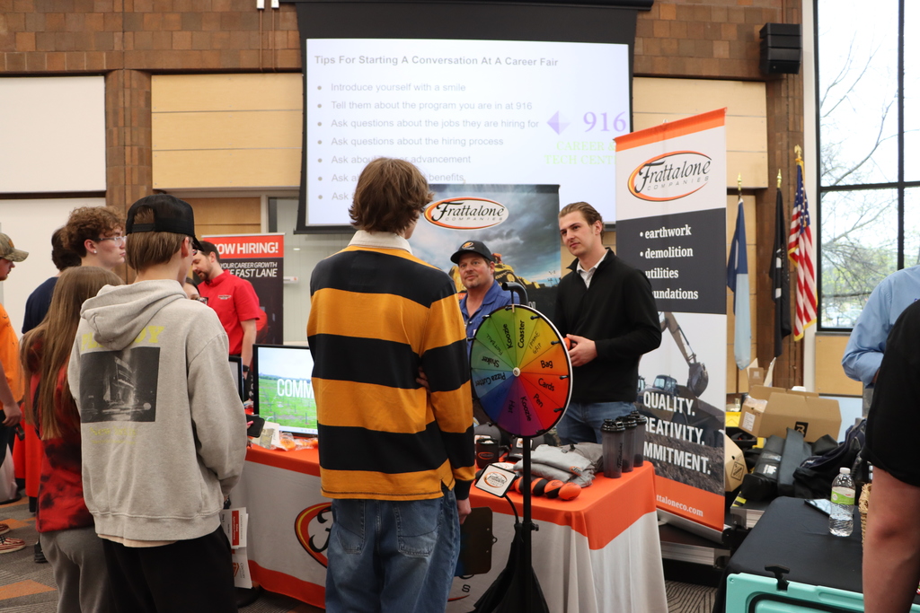 A group of students talking to industry professionals. 