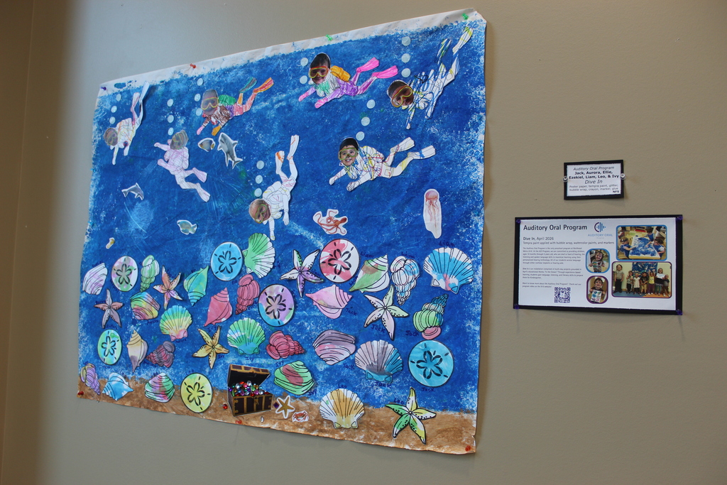 Artwork of under the sea with seashells, treasure, and students as scuba divers.