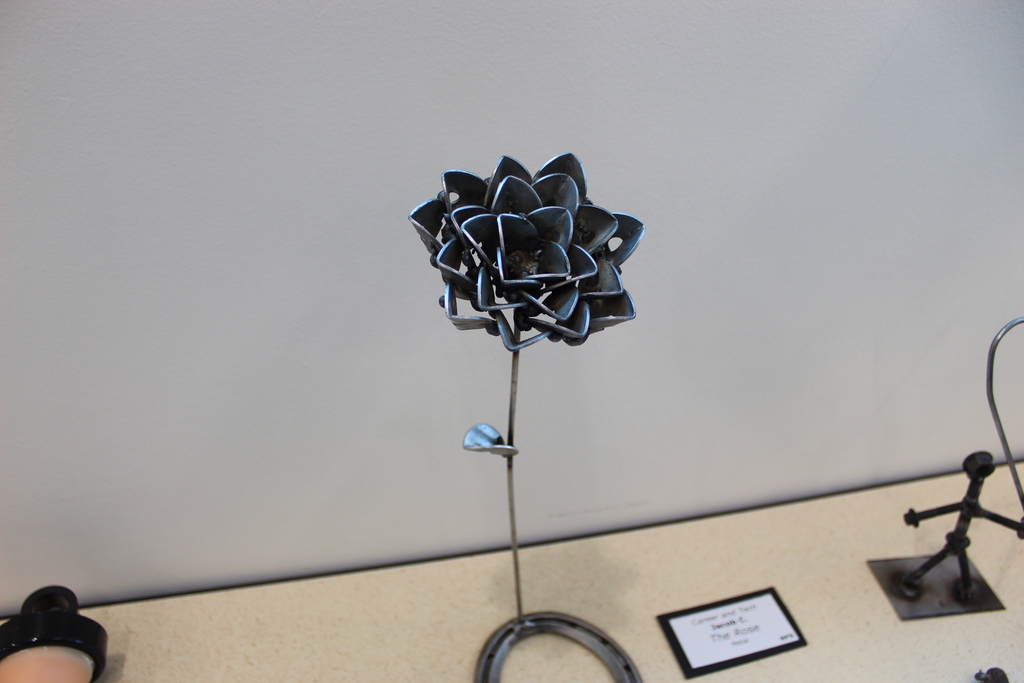 A close up image of a rose made from metal.