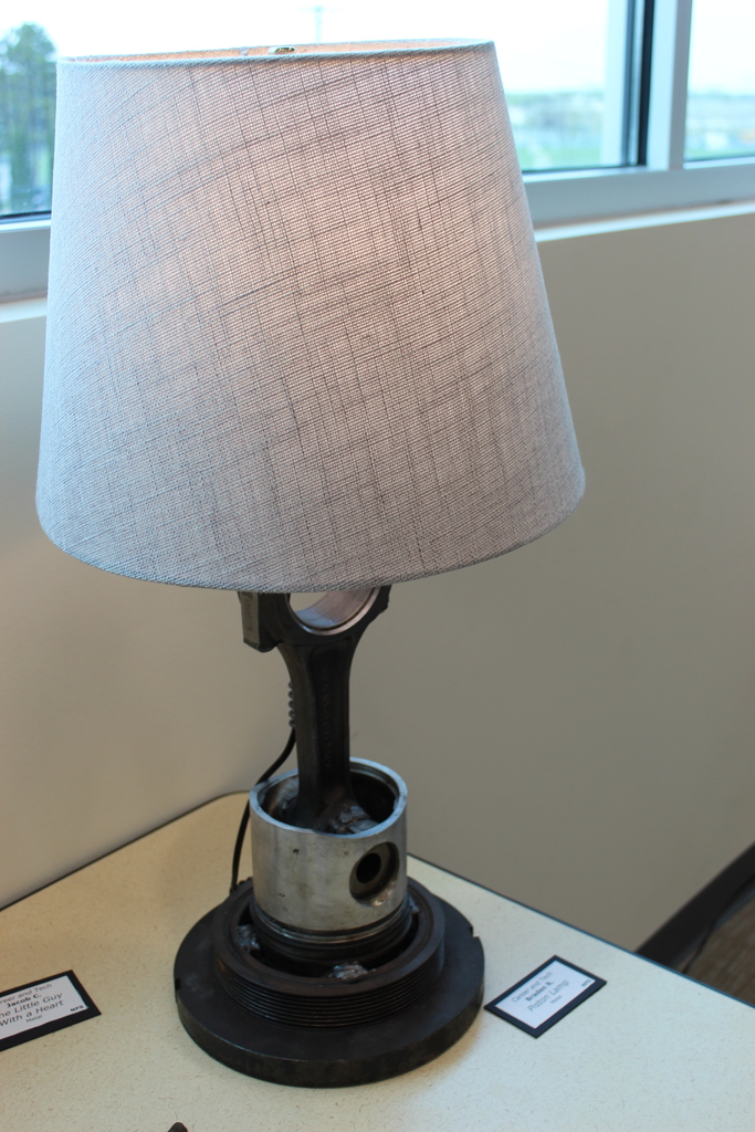 Image of a lamp with the base of the lamp made from metal art.