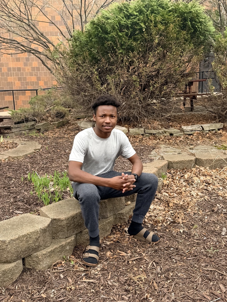 A picture of a student sitting outside.