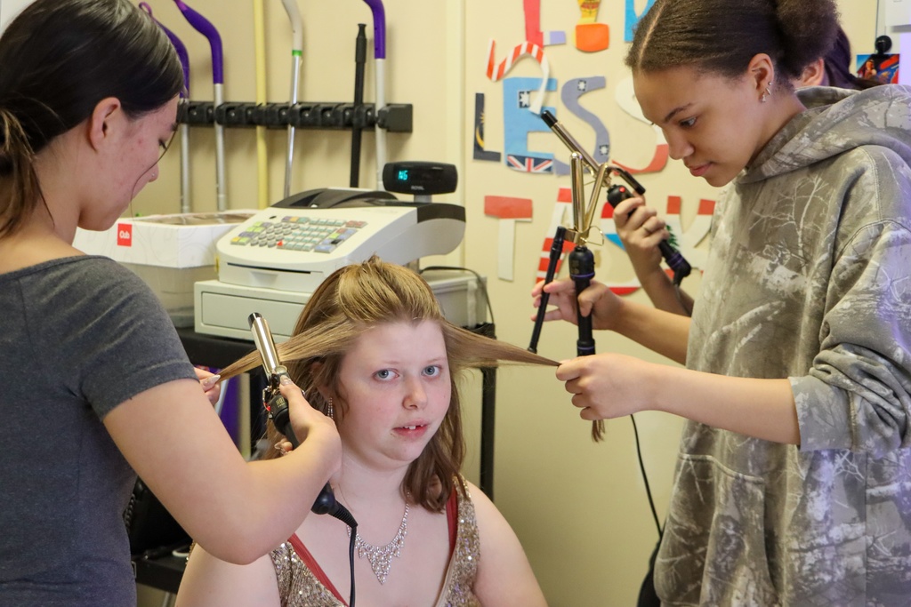 916 Career and Tech Cosmetology students doing another student's hair.