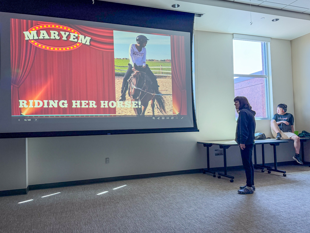 Image of a student presenting their talent is riding a horse. 