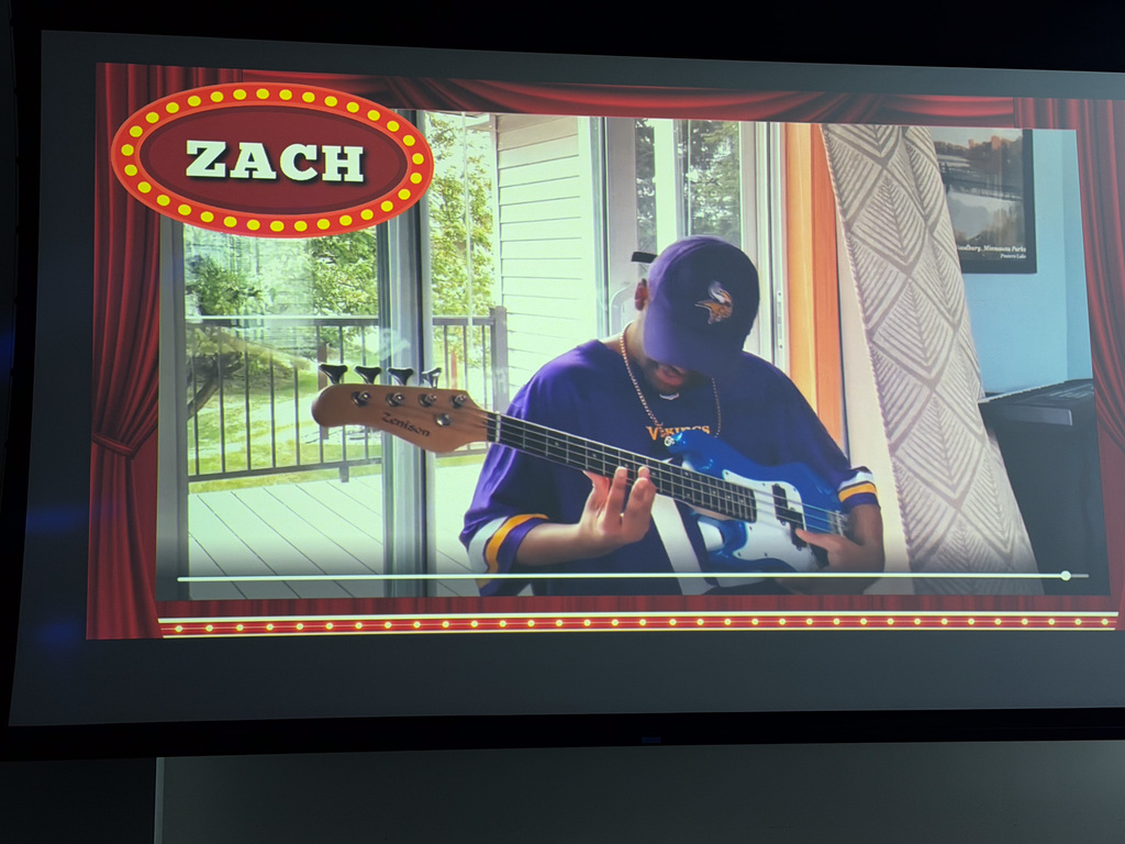 Image of a video of a student playing the guitar. 