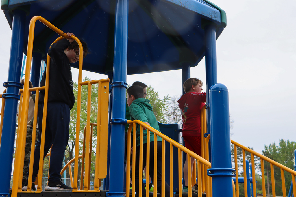 Students playing at the top of the playground. 