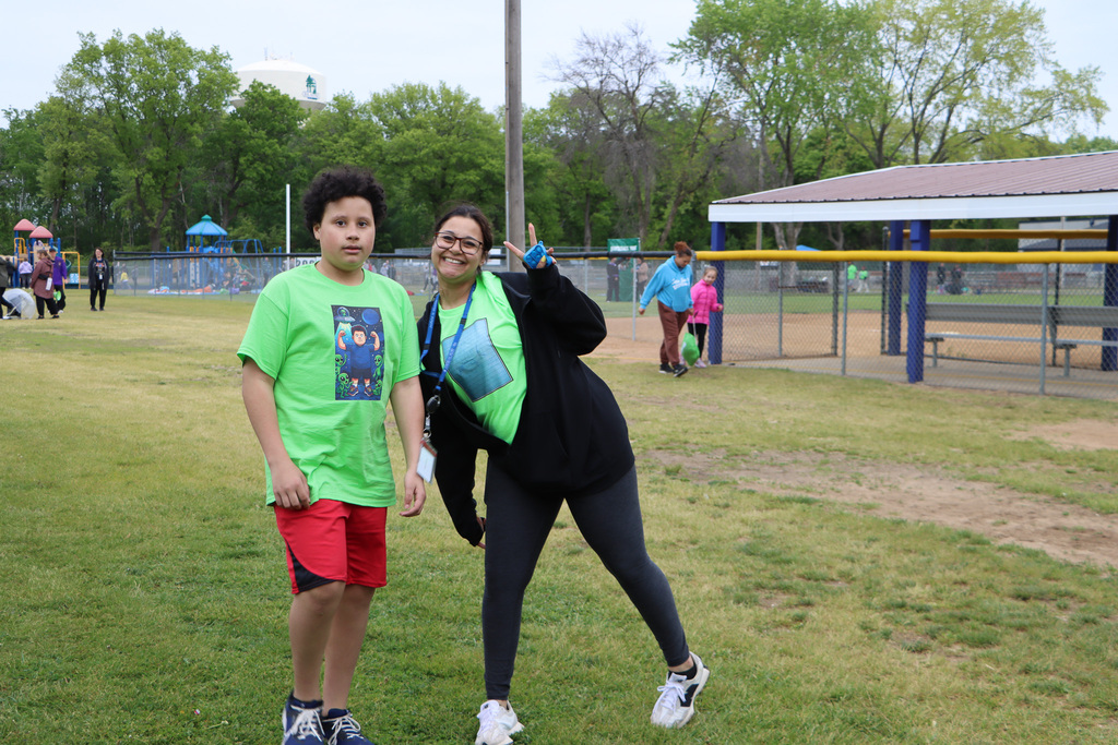Staff and student walking up with a smile. 