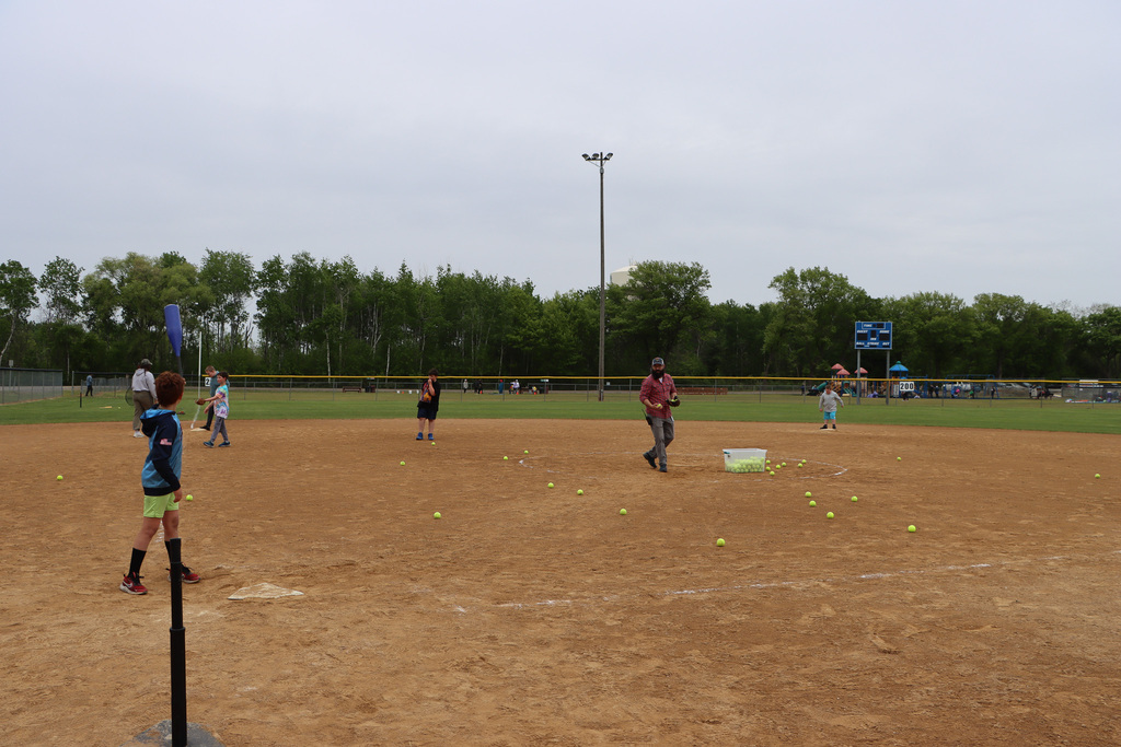 Staff and students playing t-ball.