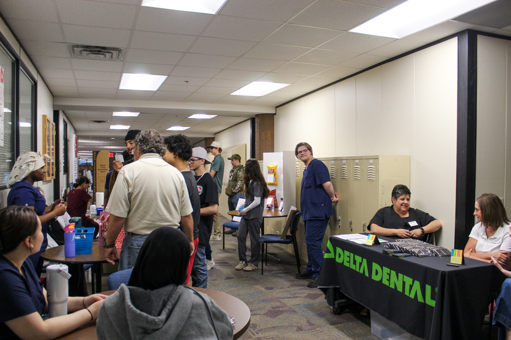 Students and staff in a hallway where a health fair is being held.