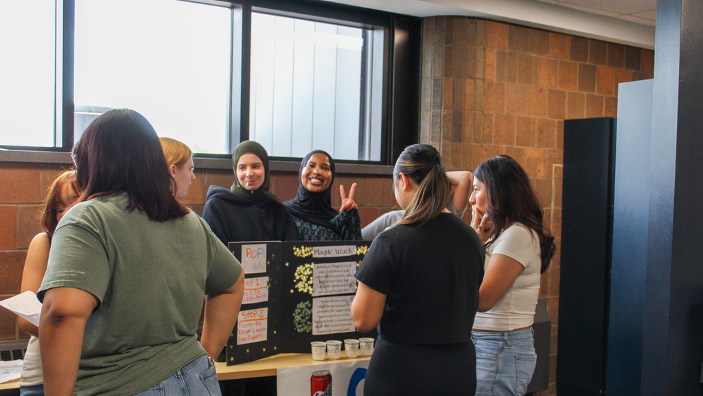 Students at a student led booth for a health fair. 