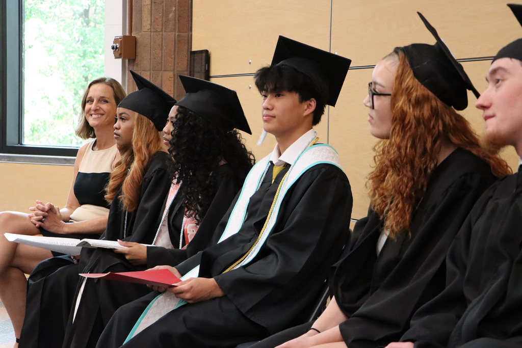 Student graduate speakers sitting as they get ready to speak.