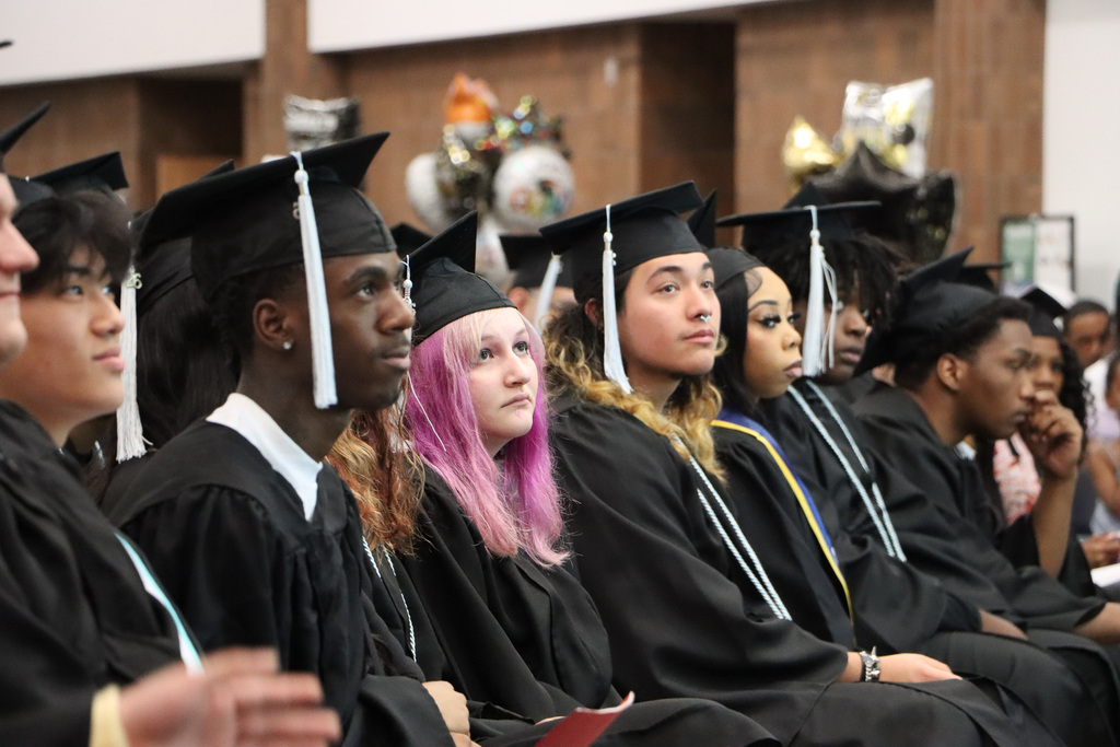 Student graduates, staff, and families attending a graduation.