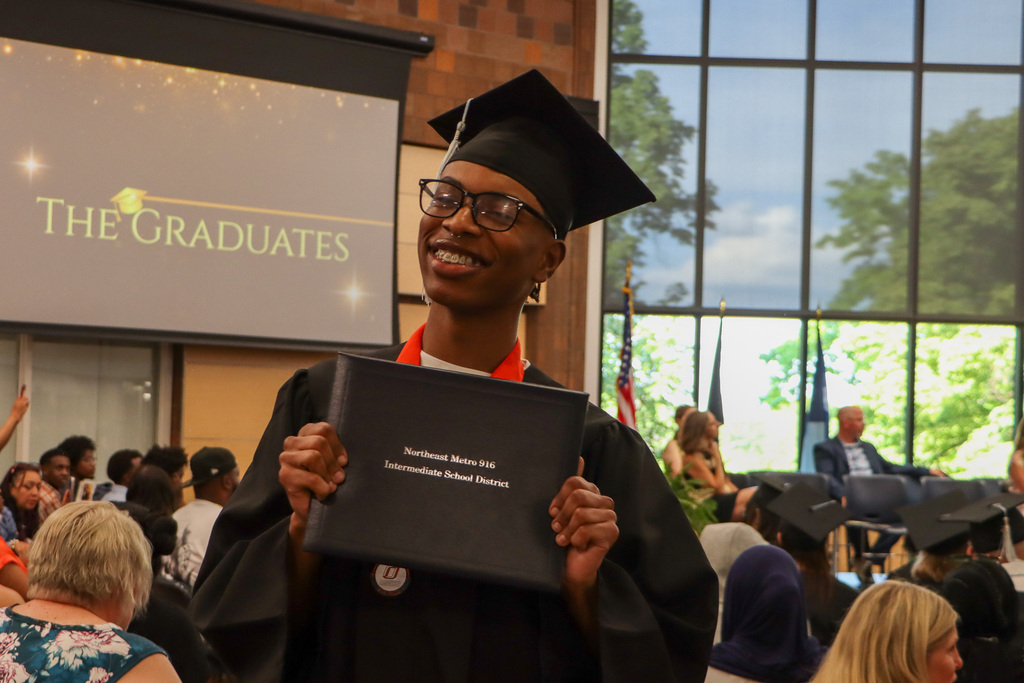 Student holding their high school diploma.