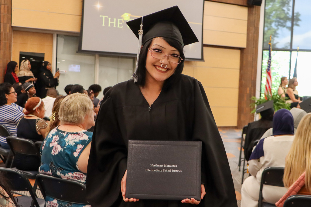 Student holding their high school diploma.