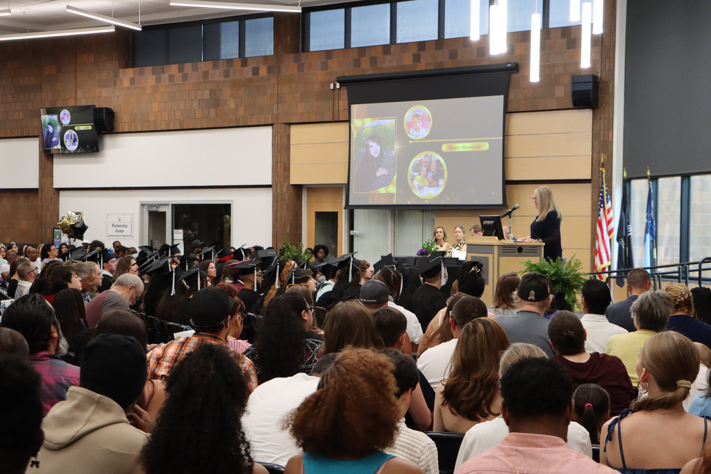 Student graduates, staff, and families attending a graduation.