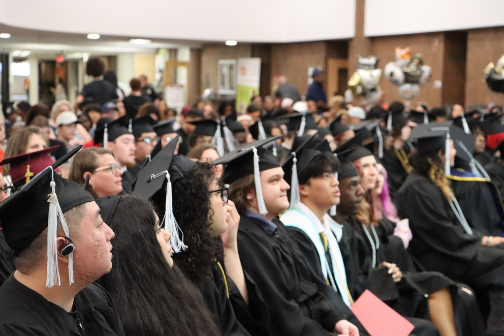 Student graduates, staff, and families attending a graduation.
