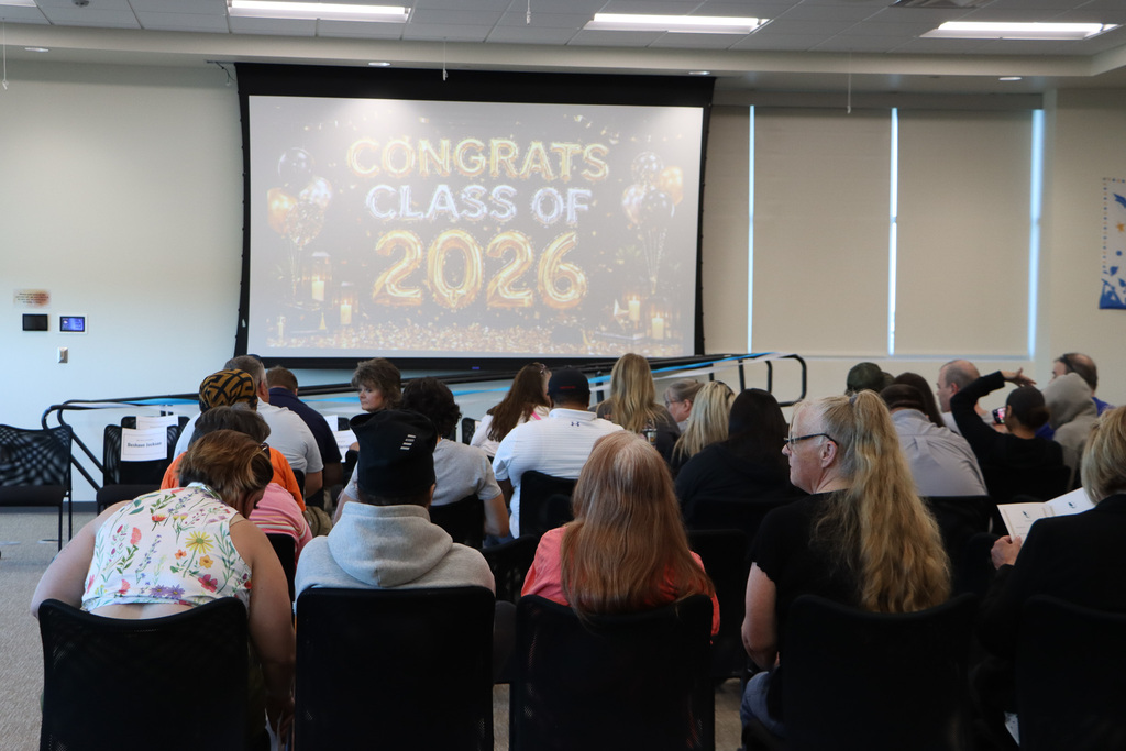 Families sitting down as they wait for the graduation ceremony to start.