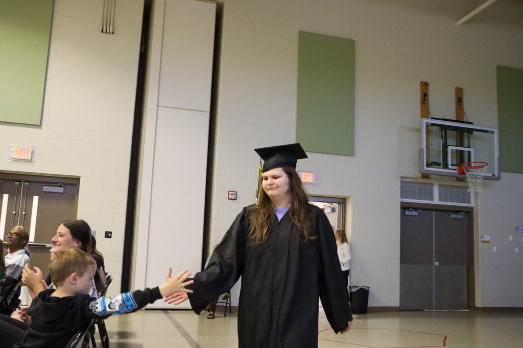 Student graduate walking into the graduation ceremony.