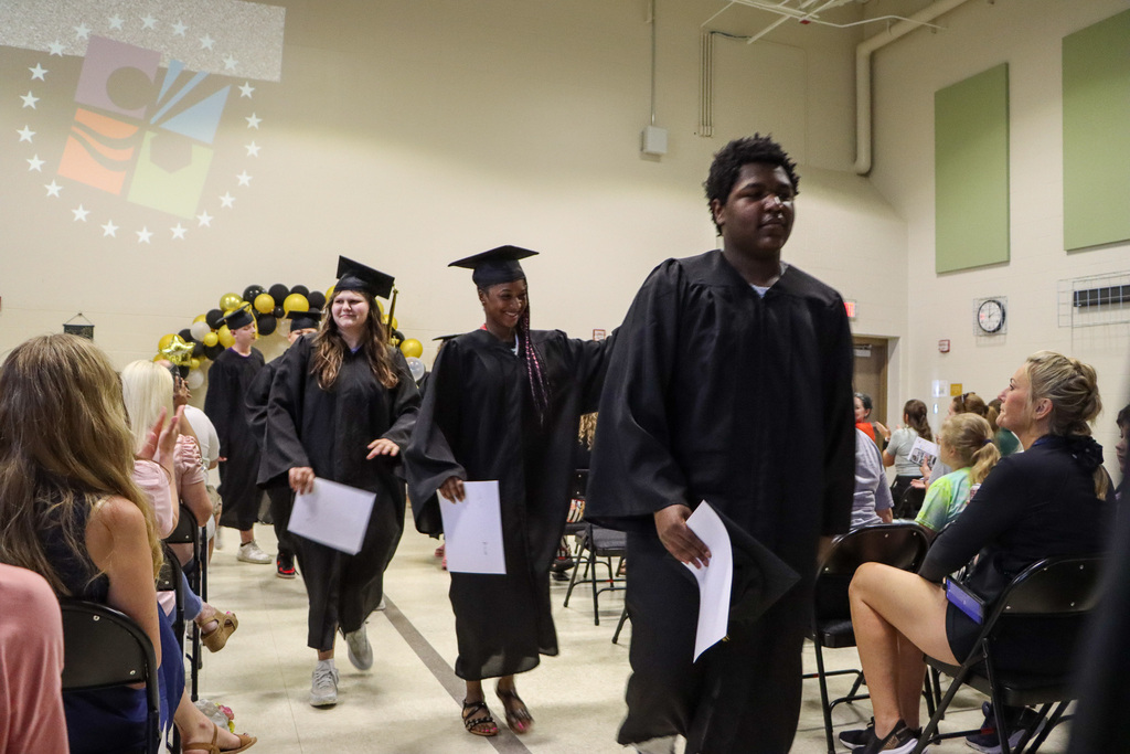 Student graduates walking out from the graduation ceremony.