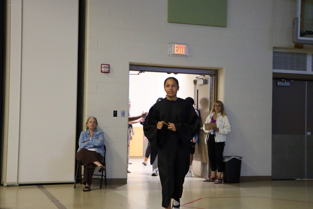 Student graduate walking into the graduation ceremony.