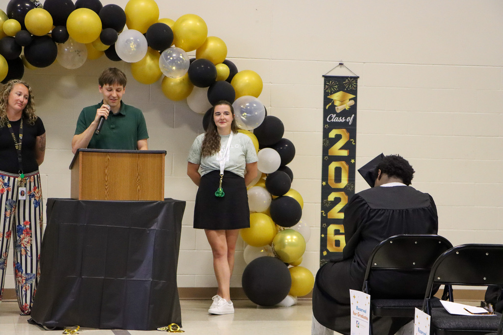 Staff giving speeches during the graduation ceremony.