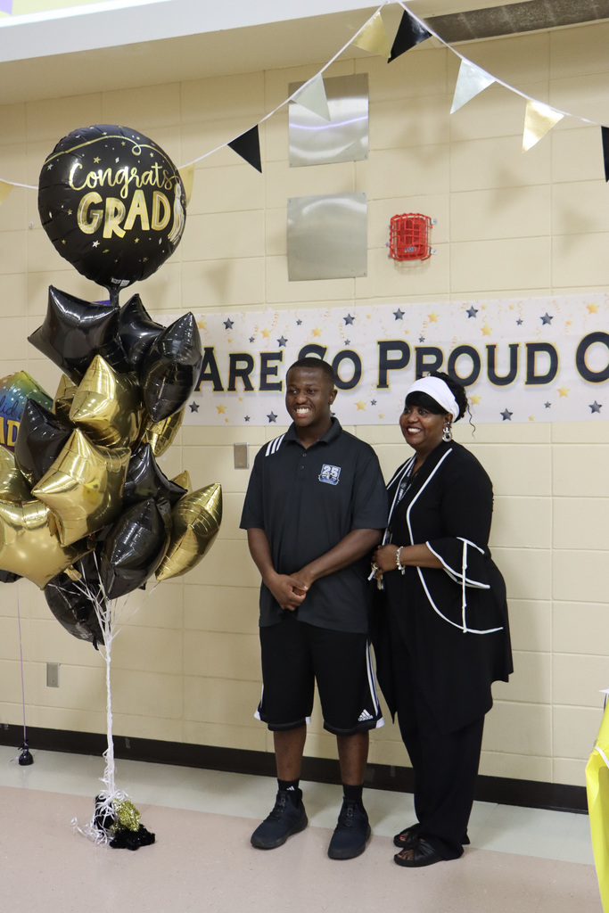 Family and student graduate smiling for camera. 