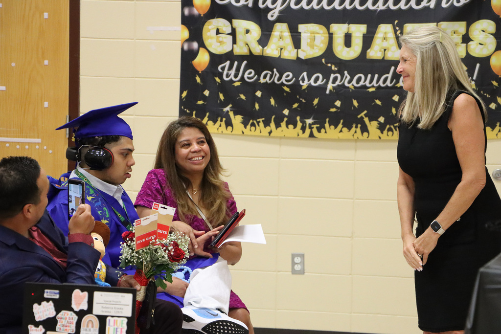 Superintendent congratulating student graduate.