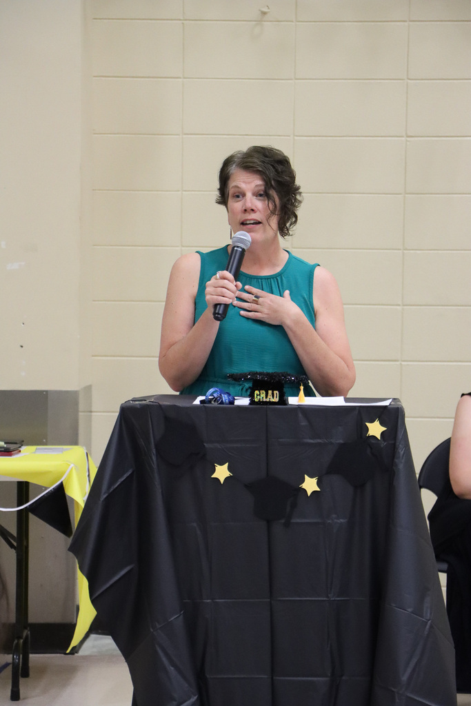 Principal giving speech during graduation ceremony.