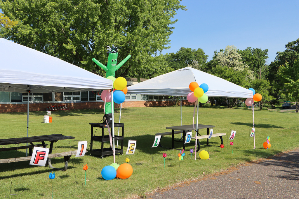 Tents, balloons, and and individual letter signs that spell out "Field Day."
