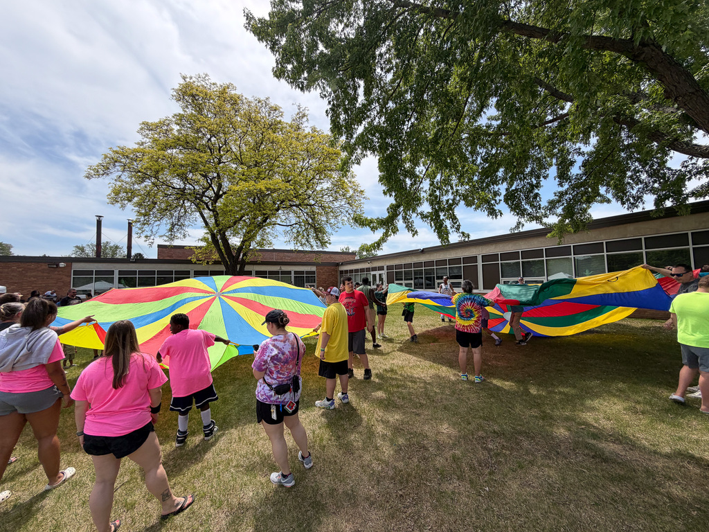 Students, families, and staff doing parachute play.