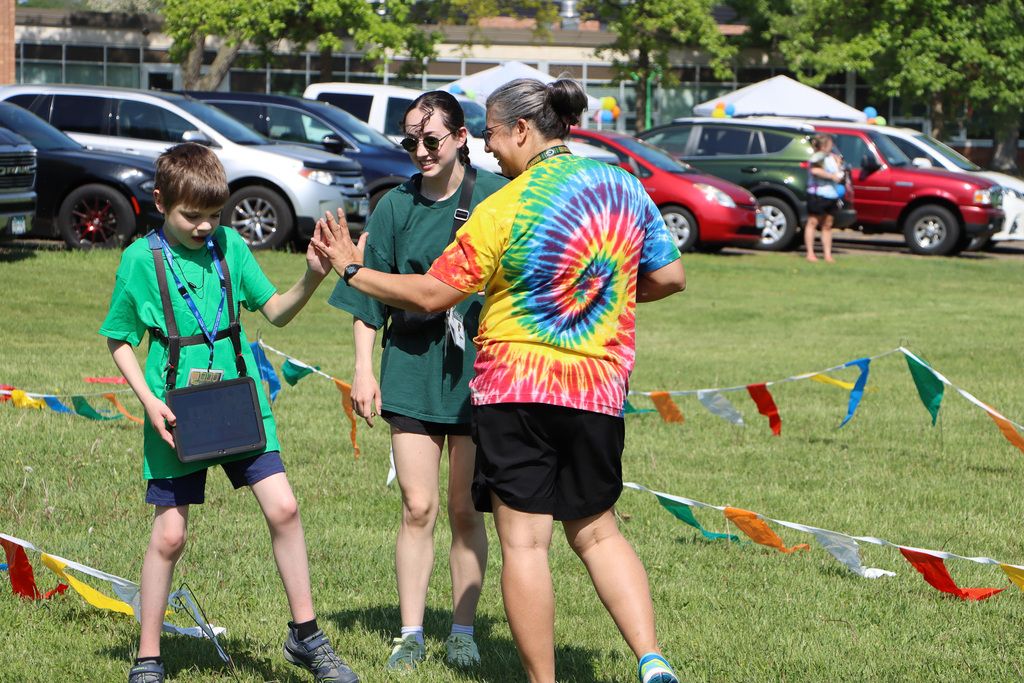 Staff giving a high five to a student for completing an activity.