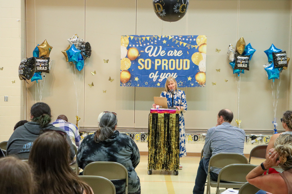 Principal making a speech during graduation ceremony.