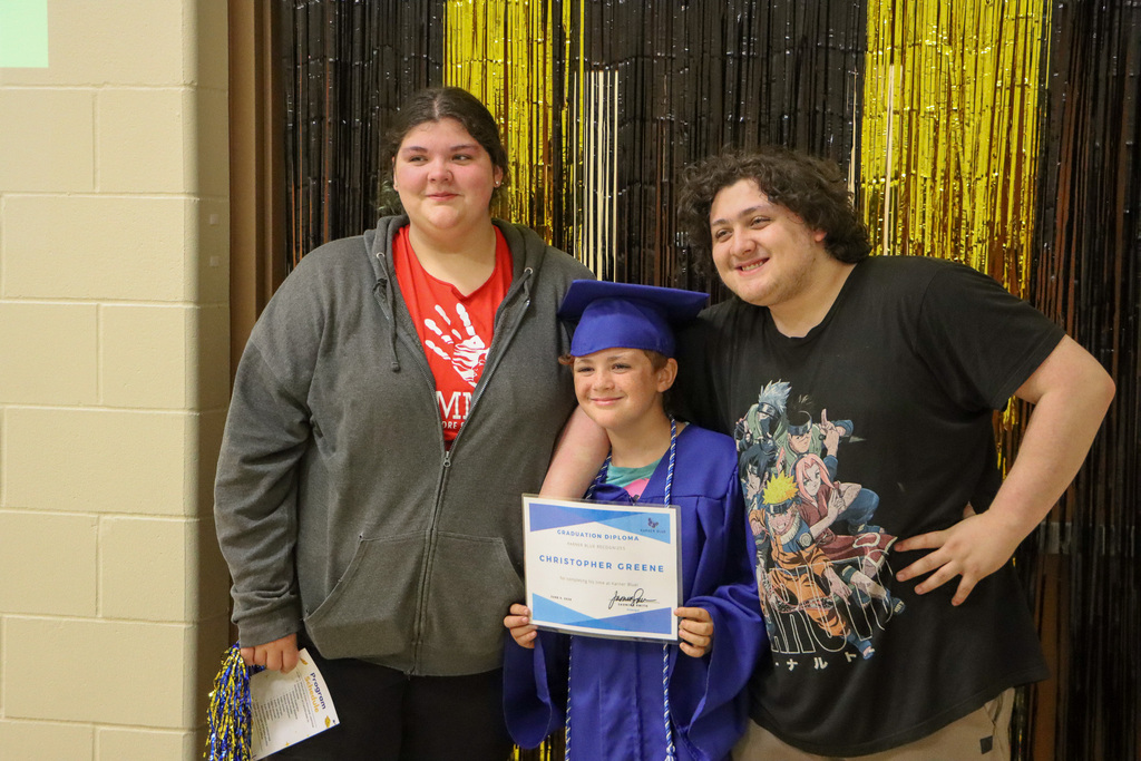 Student taking picture with family.