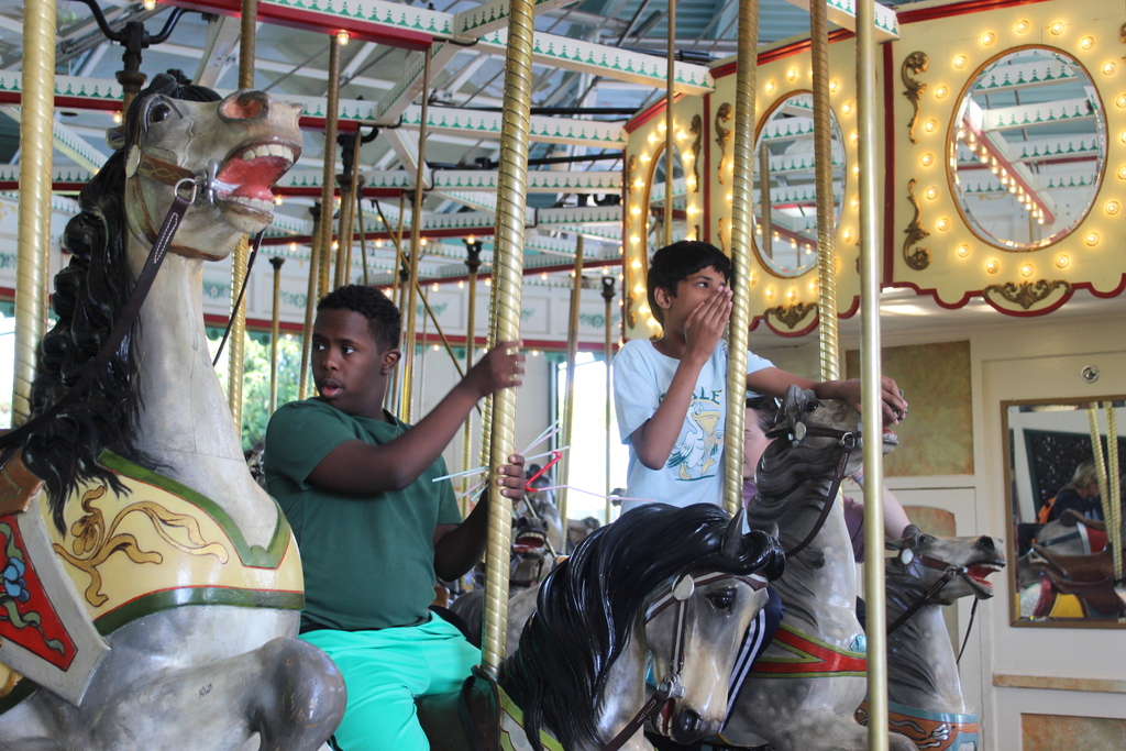 Students and staff on a carousel.